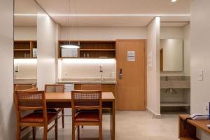 a kitchen with a table and chairs in a room at Hotel Resort em Salinópolis in Salinópolis