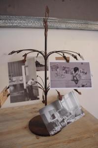 a sculpture of a tree on a table with pictures at Gite Du Passant Rennais in Rennes