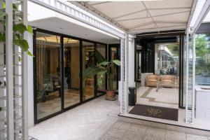 a glass extension to a house with a porch at Hotel President - Vintage Hotel in centro in Riccione