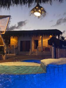 una casa con piscina por la noche en Pousada Villa Kalani, en Timbó
