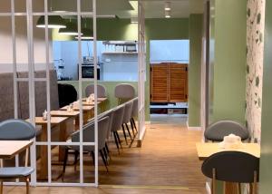 a dining room with tables and chairs and green walls at Goya Hotel in Buenos Aires +31 photos