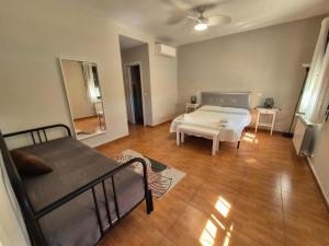 a room with a bed and a couch and a table at El Jardín de los Niños 2 in El Viso de San Juan +43 photos
