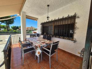 a dining room table and chairs on a patio at El Jardín de los Niños 2 in El Viso de San Juan