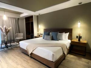 a bedroom with a large bed and a chair at Casa Olea in Mexico City +14 photos