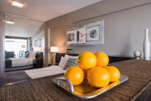 a plate of oranges on a table in a living room at Recoleta - Elite 13th floor apt with rooftop pool in Buenos Aires +27 photos