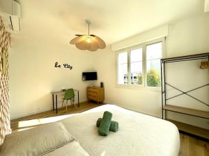 a bedroom with a bed with a teddy bear on it at Le City, Centre-ville, Climatisation, Trams in Grenoble +17 photos