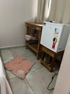 a small white refrigerator sitting on top of a floor at Pousada Pé de Cedro in Bonito
