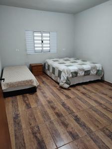 Postel nebo postele na pokoji v ubytování Chácara Esmeralda