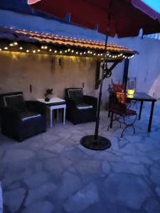 a patio with a table and chairs and an umbrella at Studio à deux pas du village in Ceyreste