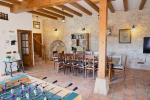a living room with a table and chairs and a dining room at Casa Rural El Mirador de la Vega in Horche