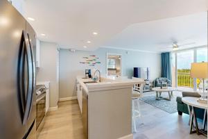 a kitchen with a refrigerator and a dining room at Sunrise Suites - Saint Kitts 412 in Key West