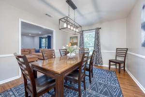 a dining room and living room with a wooden table and chairs at Near Botanical Garden with a Pool Charming on Charing in Columbus +80 photos
