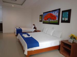 Voodi või voodid majutusasutuse Galápagos Isabela Hotel Loja toas