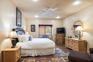 a bedroom with a large bed and a tv at Glenfiddich Condo, Deer Valley Resort, Cozy Interiors, Private Patio, Private Hot Tub, Stunning View in Park City