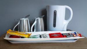 a tray with toothbrushes and a cup on a table at The Three Coopers in Bedale +9 photos