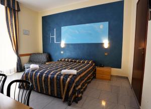 Postel nebo postele na pokoji v ubytování Hotel Loreto