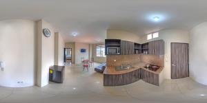 a room with a kitchen and a living room at Dreams Studios & Apartments in Puerto Ayora