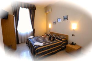Postel nebo postele na pokoji v ubytování Hotel Loreto