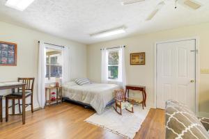 a bedroom with a bed and a desk and a table at Tennessee Farm Vacation Rental with Game Room! in Gadsden