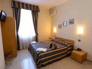 Postel nebo postele na pokoji v ubytování Hotel Loreto