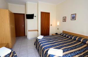 Postel nebo postele na pokoji v ubytování Hotel Loreto