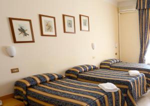 Postel nebo postele na pokoji v ubytování Hotel Loreto