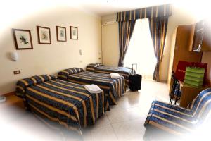 Postel nebo postele na pokoji v ubytování Hotel Loreto