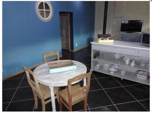 a dining room with a table and two chairs at Le Gîte Du Prieuré in Namur