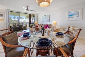 a dining room with a glass table and chairs at Gorgeous Luxury Ocean View 1 Bedroom Kamaole Sands 10-304 in Wailea