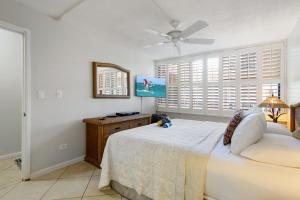 a bedroom with a bed and a ceiling fan at Gorgeous Luxury Ocean View 1 Bedroom Kamaole Sands 10-304 in Wailea +44 photos