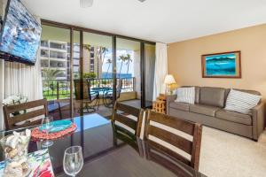 a living room with a couch and a table at Sugar Beach 207 Ocean Views in Upgraded Beachfront Condo Home in Kihei
