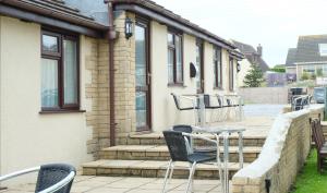 a group of chairs and a table on a patio at The Old Rectory - Brean in Brean