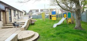 a park with a playground with a slide at The Old Rectory - Brean in Brean