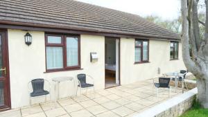 a house with chairs and a table on a patio at The Old Rectory - Brean in Brean