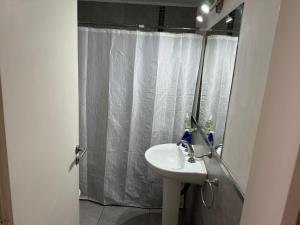 a bathroom with a sink and a shower with a mirror at Serranias de Tandil in Tandil +33 photos