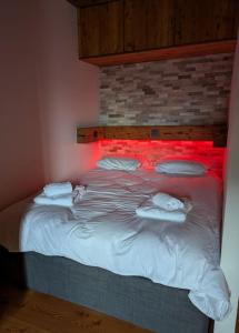 a bedroom with a bed with red lights on it at Studio Le Chamois - Veysonnaz in Veysonnaz
