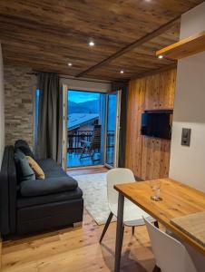 a living room with a couch and a table at Studio Le Chamois - Veysonnaz in Veysonnaz