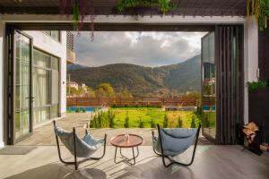 a patio with two chairs and a table and a view at Dili Dream Villa in Dilijan