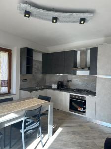 a kitchen with a table and a table and a stove at Casa Gaudi in Piancastagnaio