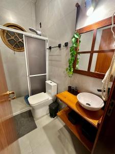 a bathroom with a white toilet and a sink at Espaço da Zilda in São José +88 photos