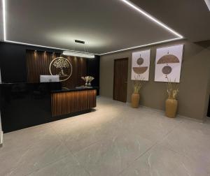 a lobby with a reception area with vases at Casa Olea in Mexico City