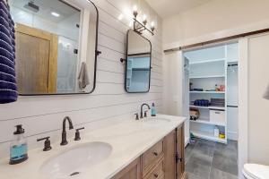 a bathroom with two sinks and a mirror at We'll Ski in Jackson +56 photos