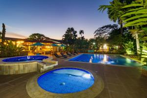 a swimming pool with two jacuzzis in a resort at NQ Hotel Orinoquia in Villavicencio +51 photos