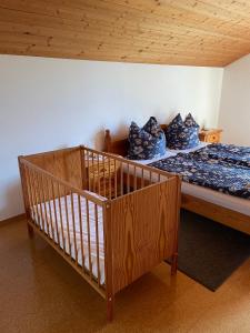 a bedroom with a bed with blue pillows on it at Esingerhof in Laufen +2 photos