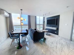 a living room with a couch and a table with chairs at Island Escape Properties 01 in Panama City