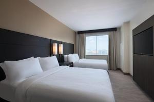 a hotel room with two beds and a flat screen tv at Residence Inn by Marriott Corpus Christi South in Corpus Christi +17 photos