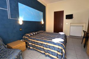 Postel nebo postele na pokoji v ubytování Hotel Loreto