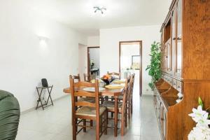 a dining room with a wooden table and chairs at Modern apartment in Vilamoura with shared pool in Vilamoura