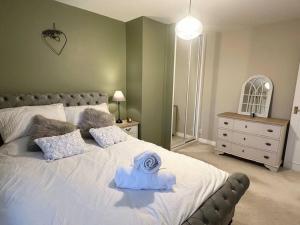 a bedroom with a bed with a towel on it at Royal Hillsborough Hideaway in Hillsborough +14 photos