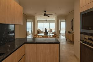 a kitchen with a table and a living room at Sierra Mar in Isla Mujeres